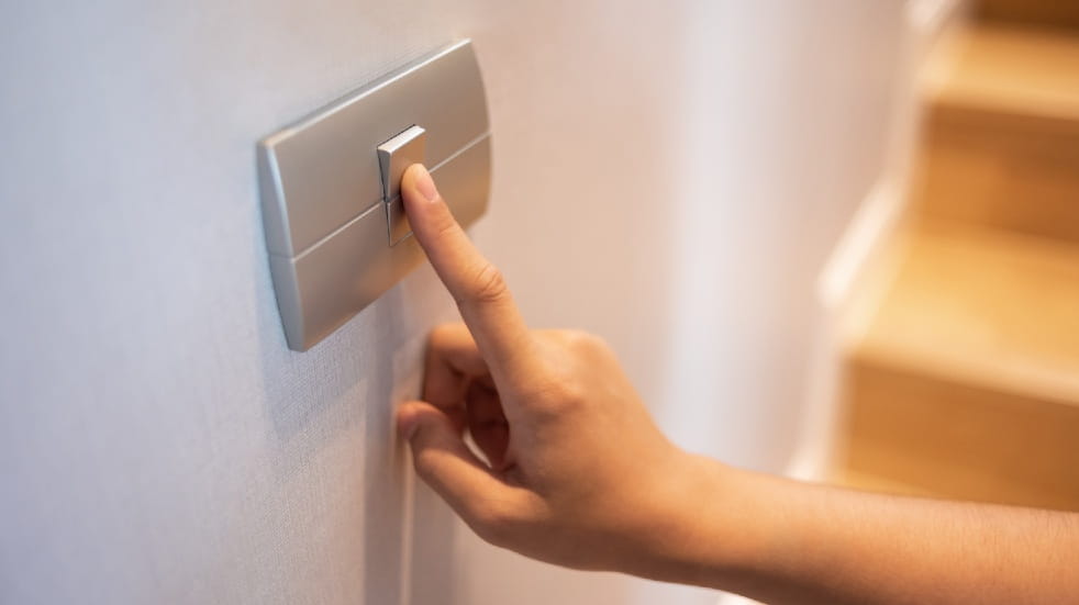 How to save money by switching energy providers finger on light switch